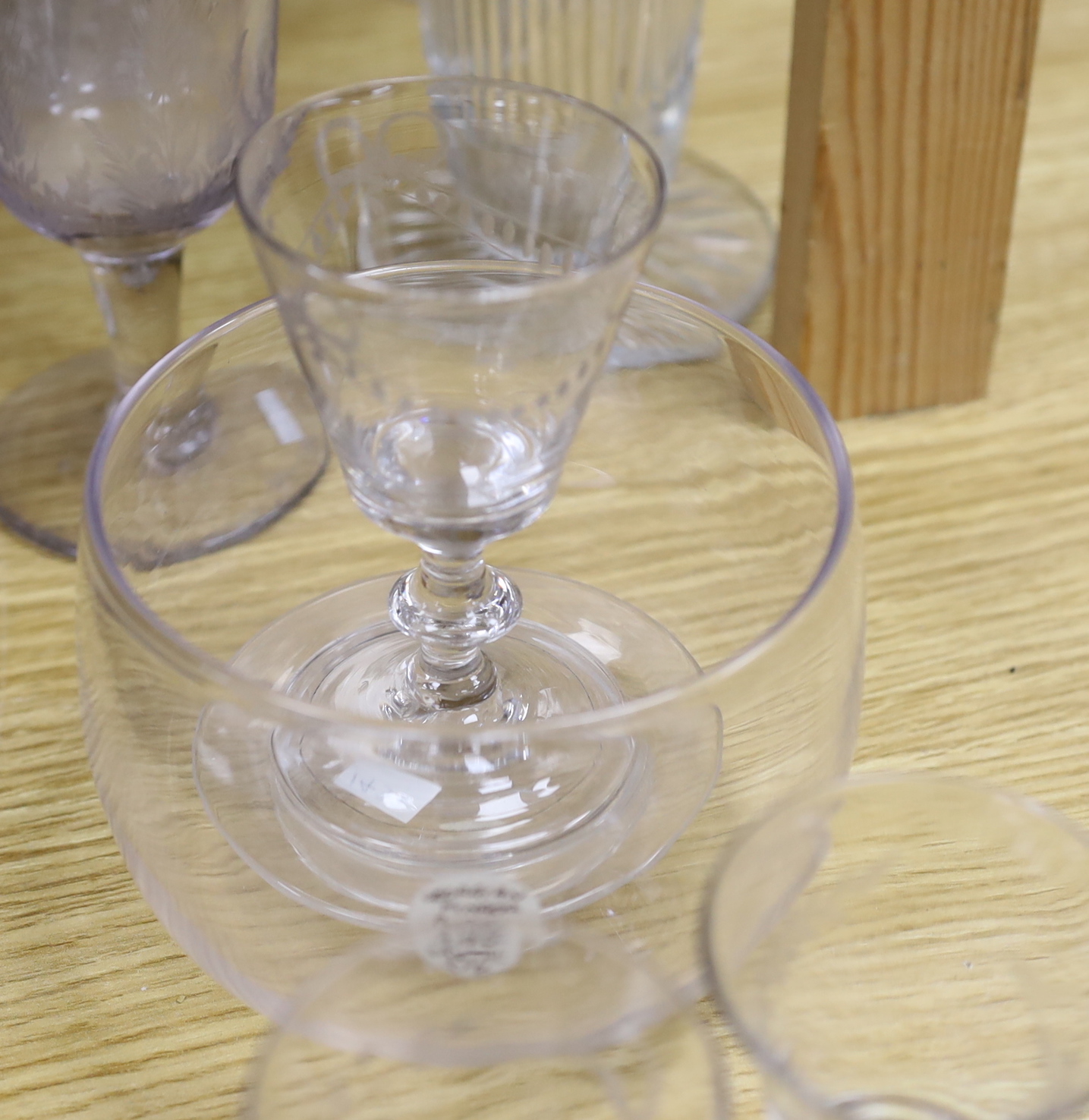 A collection of 18th and 19th century drinking glasses, etc. including rummers, engraved sherry glasses with knobbed stems, folded feet and broken pontils, a cut glass goblet, a Georgian finger bowl and stand, two vases,